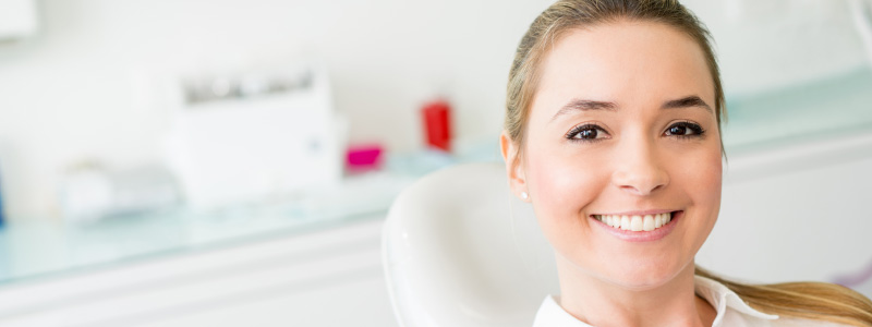 girl with cavity sitting in dental chair