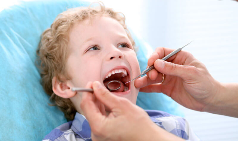 young boy getting a dental exam