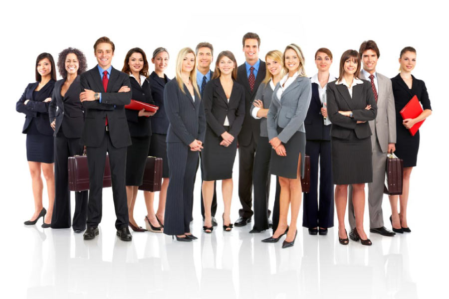 A standing group of male and female professionals dressed in business attire.