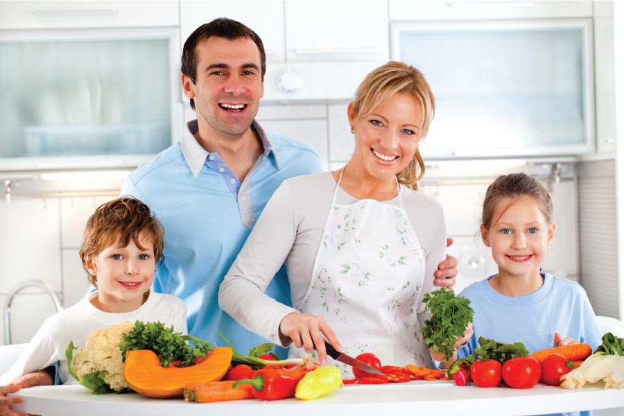 Young family in the kitchen with healthy foods on the kitchen island.