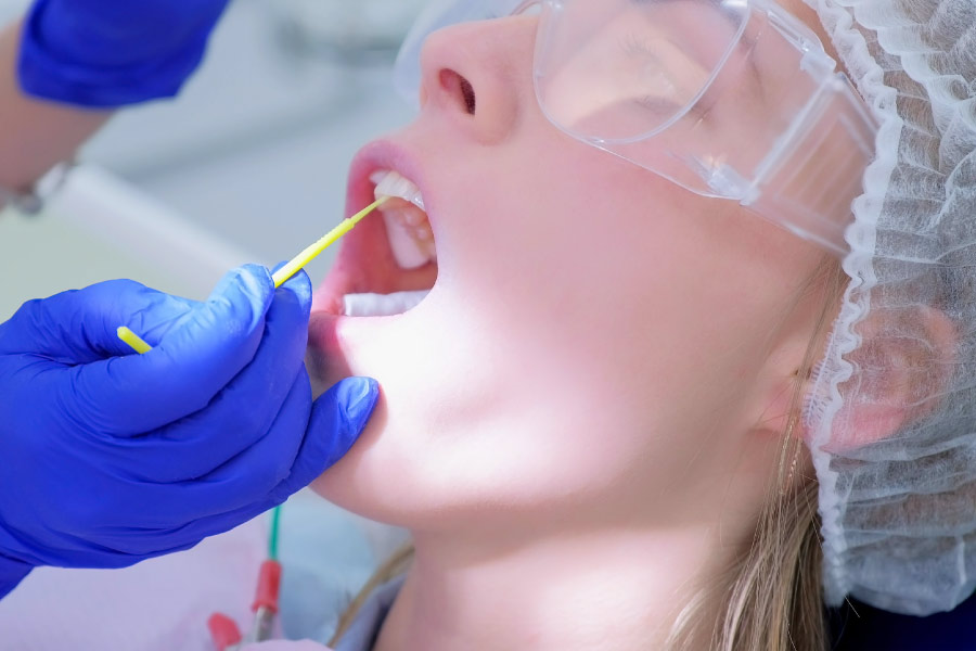 Adult woman receiving a fluoride treatment.